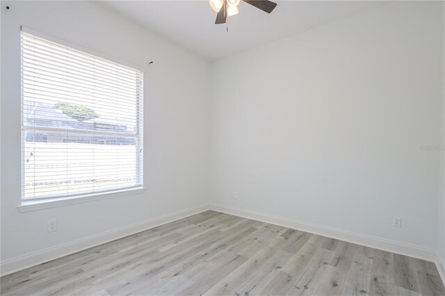 8023 Canyon Lake Cir, Orlando, FL 32835 - unfurnished room with light wood finished floors, a ceiling fan, and baseboards