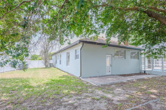 8023 Canyon Lake Cir, Orlando, FL 32835 - back of property featuring stucco siding, a patio area, and a chimney