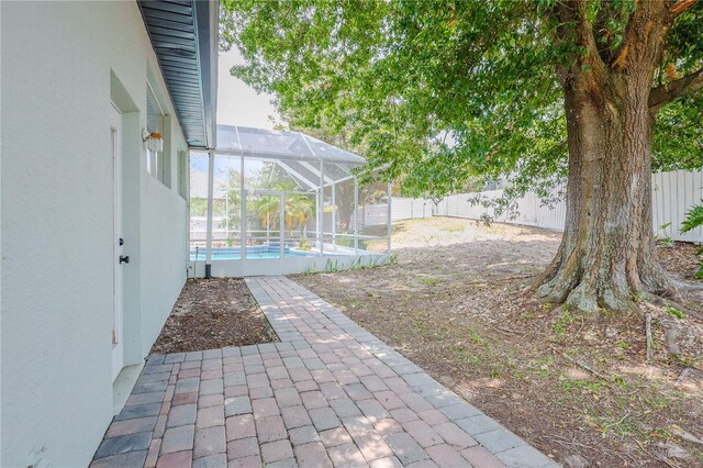 8023 Canyon Lake Cir, Orlando, FL 32835 - fenced backyard featuring a patio and glass enclosure