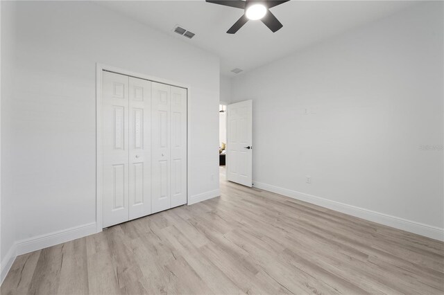 2668 Dennis Ave SE, Palm Bay, FL 32909 - unfurnished bedroom with a closet, a ceiling fan, visible vents, light wood finished floors, and baseboards