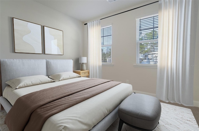 carpeted bedroom featuring baseboards
