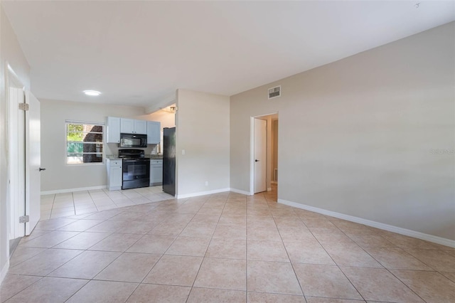 unfurnished living room with light tile patterned flooring, baseboards, and visible vents