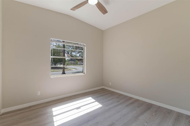 spare room featuring baseboards, a ceiling fan, and wood finished floors