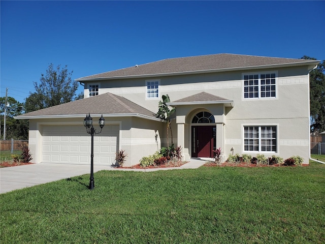 traditional-style home featuring a front lawn, stucco siding, a garage, and concrete driveway