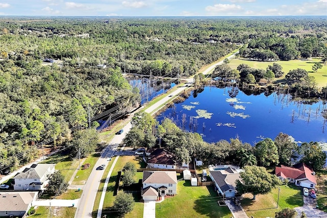 birds eye view of property with a forest view and a water view
