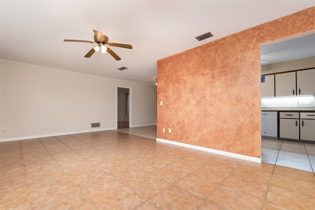 empty room featuring ceiling fan, baseboards, and visible vents