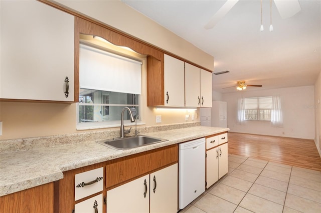 kitchen with dishwasher, a sink, light countertops, ceiling fan, and light tile patterned flooring