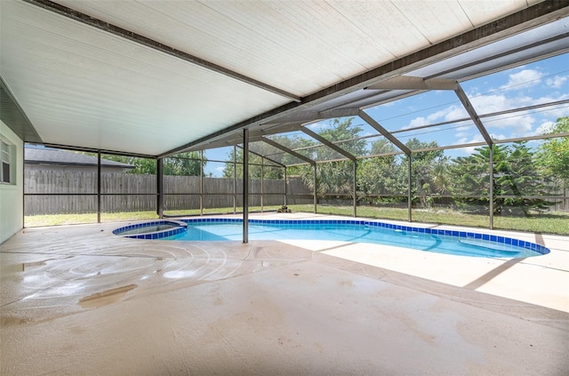 view of swimming pool featuring a lanai, a patio, a pool with connected hot tub, and fence