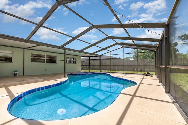 view of pool with fence, a fenced in pool, a patio, and glass enclosure