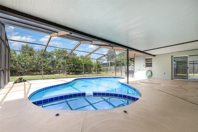 view of pool featuring a pool with connected hot tub, glass enclosure, and a patio