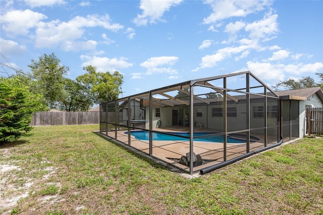 view of pool with a fenced in pool, a patio area, a fenced backyard, a yard, and glass enclosure