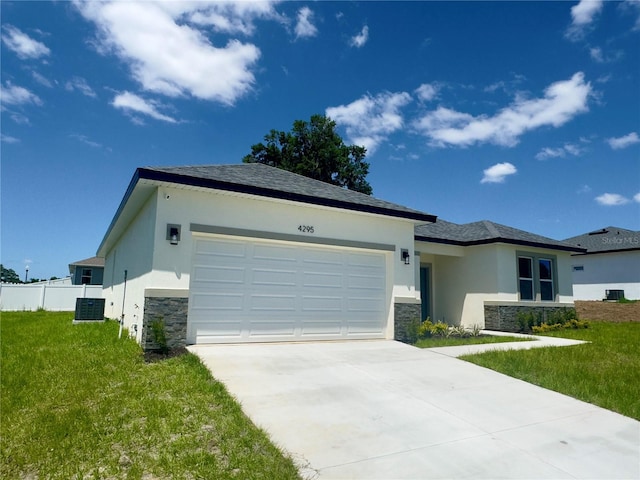 view of front of home with stone siding, stucco siding, an attached garage, concrete driveway, and central air condition unit