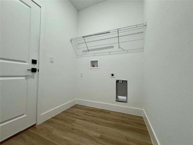 clothes washing area featuring hookup for a washing machine, wood finished floors, baseboards, and hookup for an electric dryer