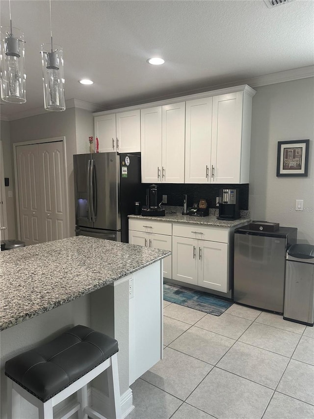 2137 Apian Way, Port Charlotte, FL 33953 - kitchen with stainless steel fridge with ice dispenser, ornamental molding, white cabinetry, light stone counters, and tasteful backsplash