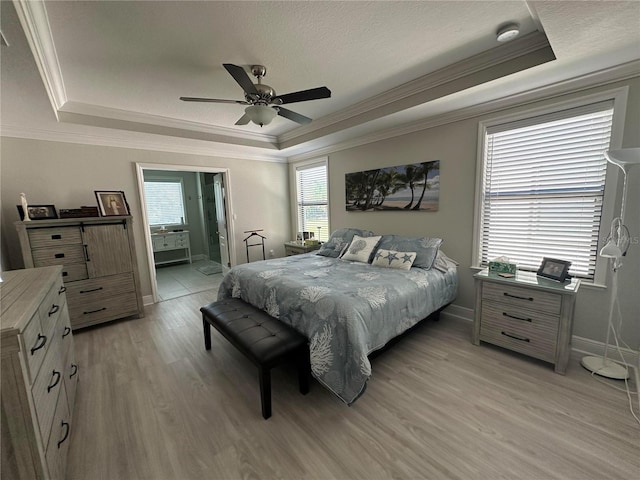 2137 Apian Way, Port Charlotte, FL 33953 - bedroom featuring a raised ceiling, crown molding, light wood-style flooring, baseboards, and a ceiling fan