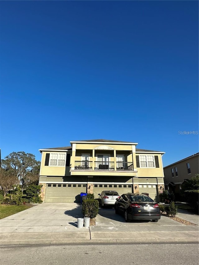 2125 Betsy Ross Ln, Saint Cloud, FL 34769 - view of front of house featuring a garage, concrete driveway, and a balcony