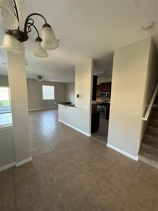 2125 Betsy Ross Ln, Saint Cloud, FL 34769 - interior space with a textured ceiling, ceiling fan, baseboards, and tile patterned flooring