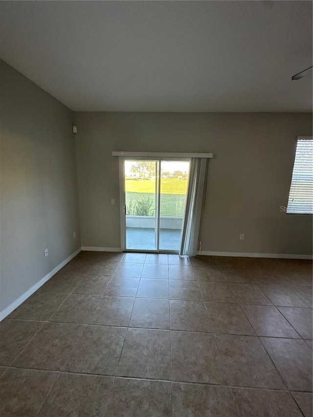 2125 Betsy Ross Ln, Saint Cloud, FL 34769 - unfurnished room with tile patterned floors, baseboards, and a healthy amount of sunlight