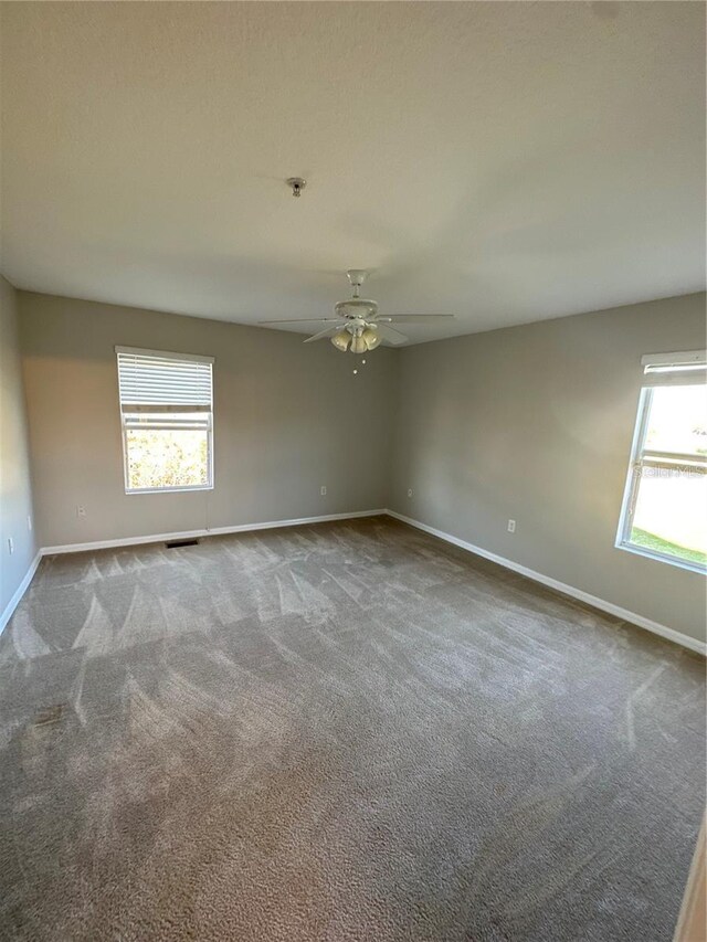 2125 Betsy Ross Ln, Saint Cloud, FL 34769 - carpeted spare room featuring ceiling fan, baseboards, and visible vents
