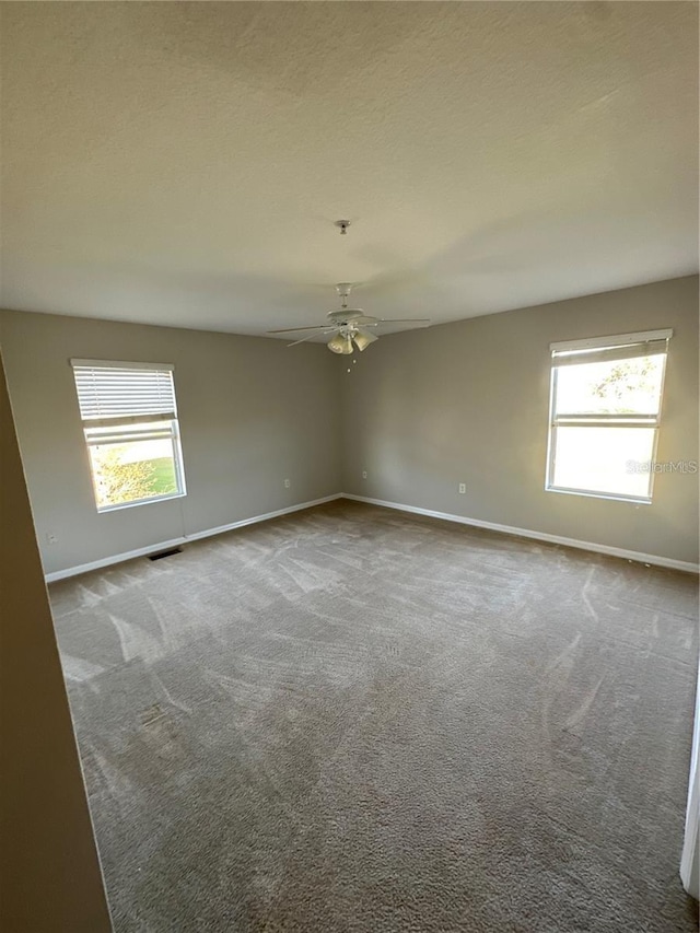 2125 Betsy Ross Ln, Saint Cloud, FL 34769 - unfurnished room with baseboards, carpet, and a healthy amount of sunlight