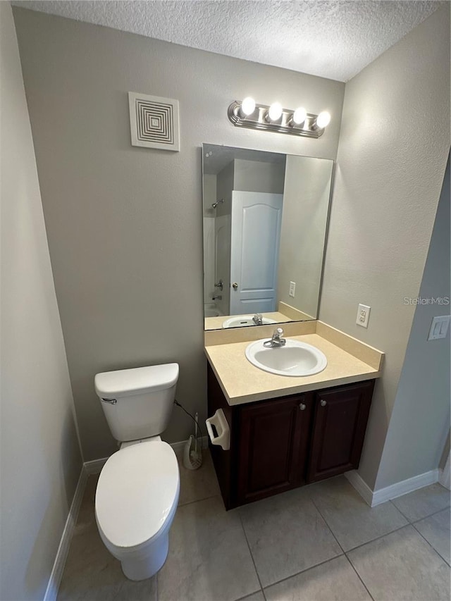 2125 Betsy Ross Ln, Saint Cloud, FL 34769 - full bathroom with vanity, tile patterned flooring, a textured ceiling, walk in shower, and toilet