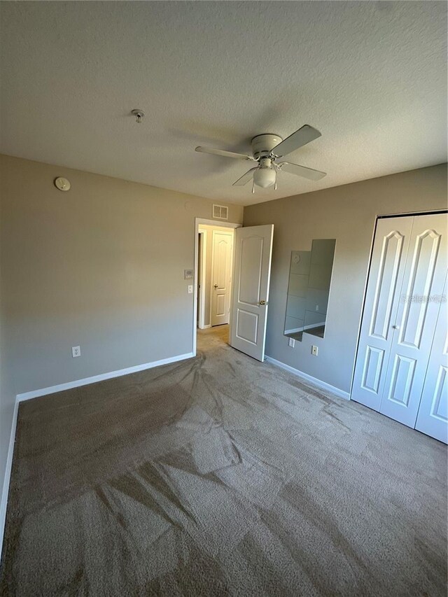2125 Betsy Ross Ln, Saint Cloud, FL 34769 - unfurnished bedroom featuring carpet, visible vents, baseboards, and a textured ceiling