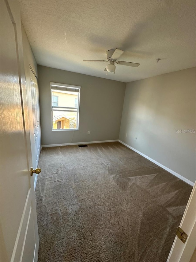 2125 Betsy Ross Ln, Saint Cloud, FL 34769 - carpeted spare room featuring a textured ceiling, ceiling fan, and baseboards