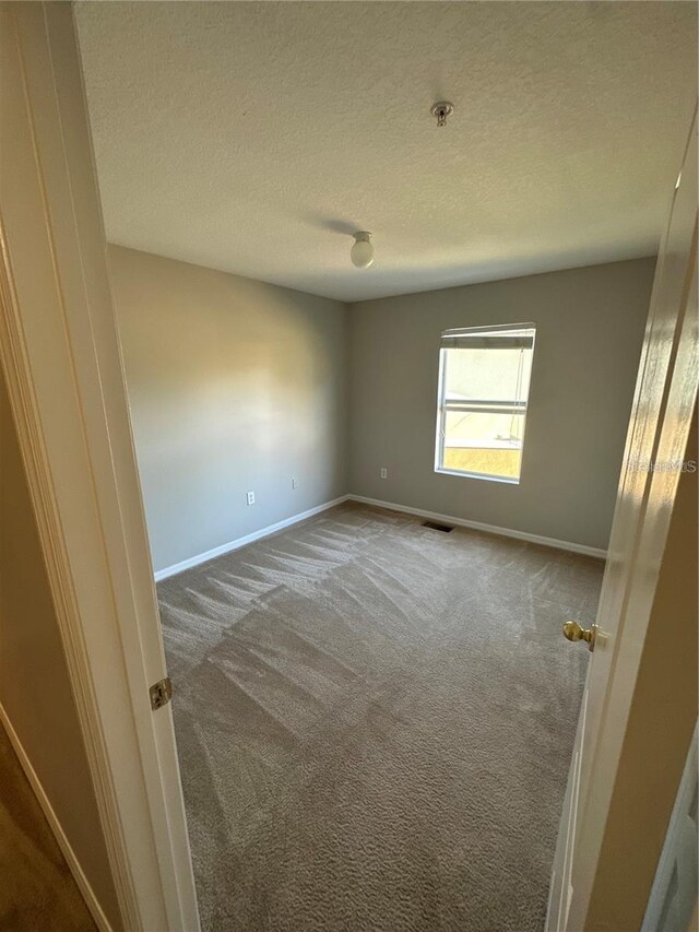 2125 Betsy Ross Ln, Saint Cloud, FL 34769 - unfurnished room featuring visible vents, baseboards, and carpet floors