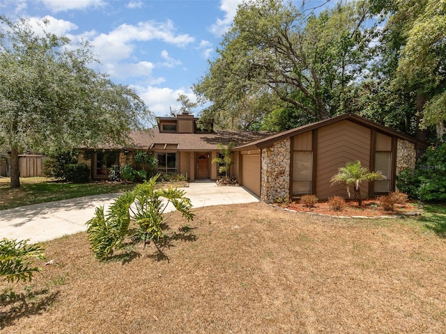 490 Burnt Tree Ln, Apopka, FL 32712 - mid-century home featuring concrete driveway, a front lawn, stone siding, and a garage