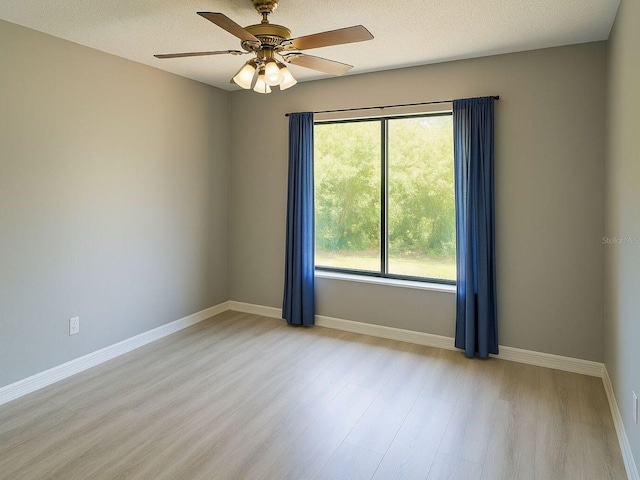 490 Burnt Tree Ln, Apopka, FL 32712 - unfurnished room featuring a ceiling fan, baseboards, light wood-style flooring, and a textured ceiling