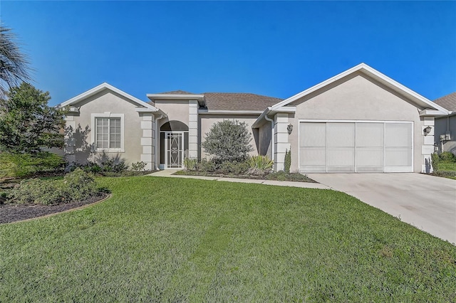ranch-style home with concrete driveway, a front yard, an attached garage, and stucco siding