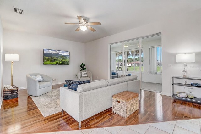 1900 NW 57th Ct, Ocala, FL 34482 - living room featuring wood finished floors, a ceiling fan, and baseboards