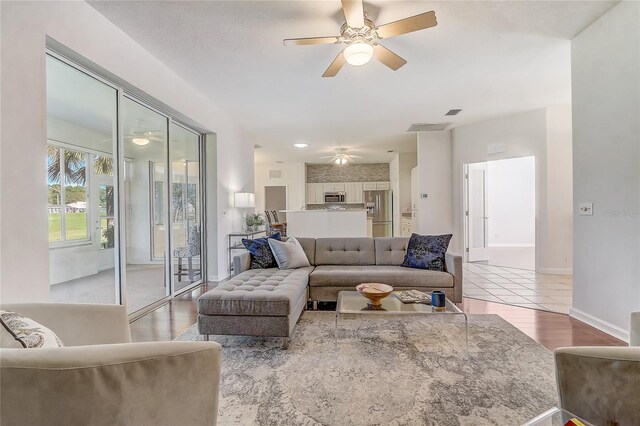 1900 NW 57th Ct, Ocala, FL 34482 - living area featuring ceiling fan, wood finished floors, and baseboards