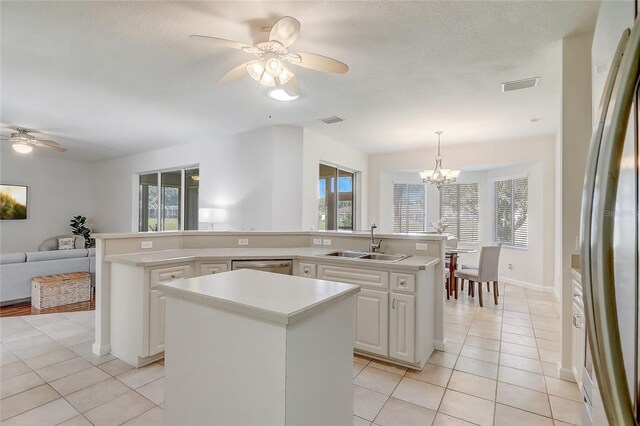1900 NW 57th Ct, Ocala, FL 34482 - kitchen with a sink, a kitchen island, ceiling fan, light tile patterned floors, and stainless steel appliances