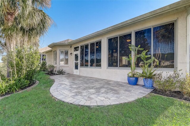 1900 NW 57th Ct, Ocala, FL 34482 - back of house featuring a patio, stucco siding, and a yard