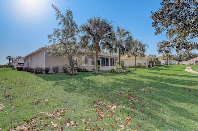 1900 NW 57th Ct, Ocala, FL 34482 - rear view of house with stucco siding and a lawn