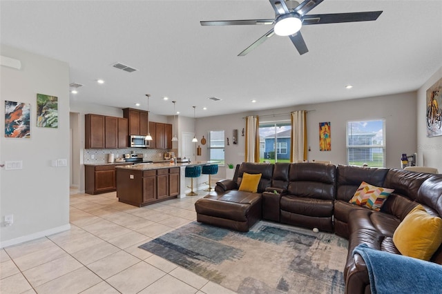 living area with visible vents, baseboards, a ceiling fan, recessed lighting, and light tile patterned flooring