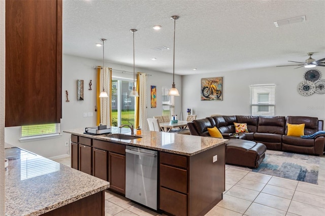 kitchen featuring open floor plan, light tile patterned floors, a ceiling fan, dishwasher, and a sink