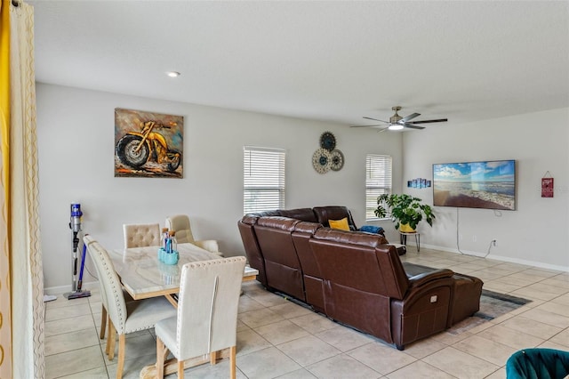 dining area with baseboards, a ceiling fan, and light tile patterned flooring