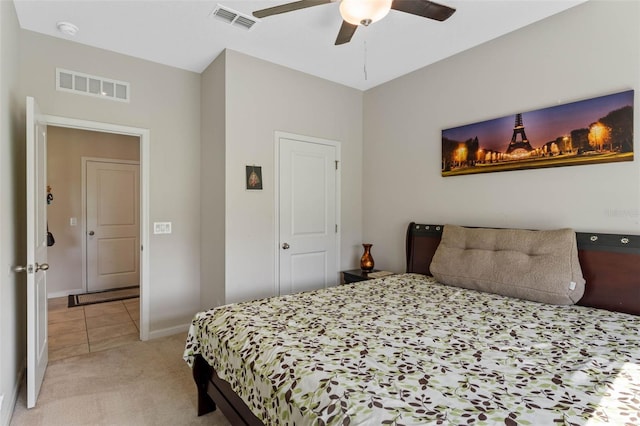 bedroom featuring visible vents, light colored carpet, baseboards, and ceiling fan
