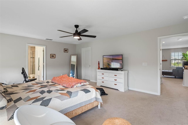 carpeted bedroom featuring baseboards, a ceiling fan, and visible vents