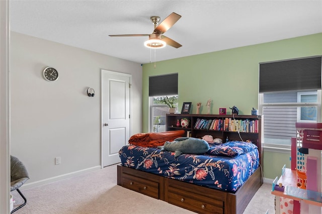 bedroom with carpet flooring, baseboards, and a ceiling fan