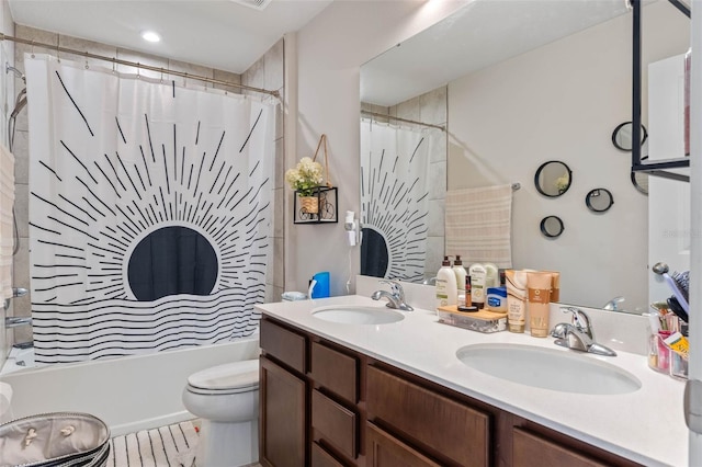 full bathroom featuring a sink, shower / tub combo, toilet, and double vanity
