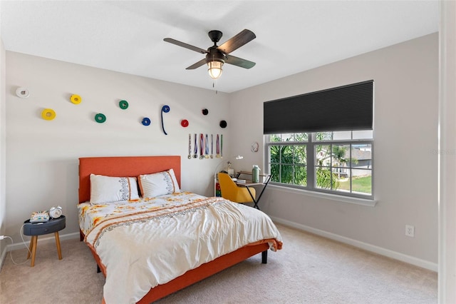 carpeted bedroom featuring baseboards and a ceiling fan