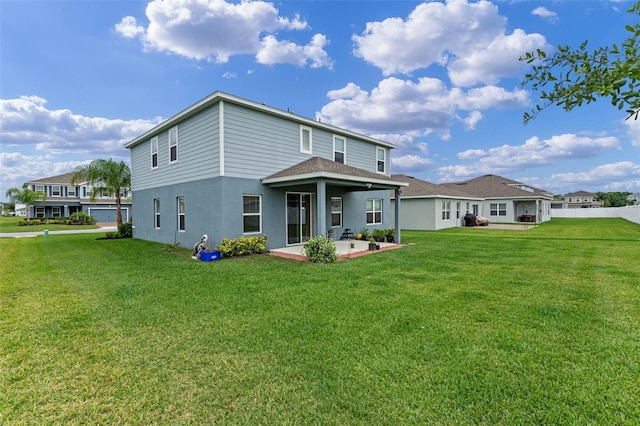 rear view of house with a patio area, roof with shingles, a yard, and stucco siding