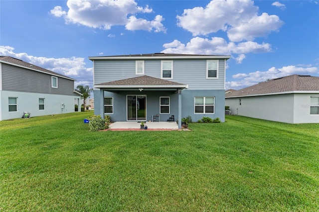 back of property featuring a patio area, roof with shingles, and a lawn