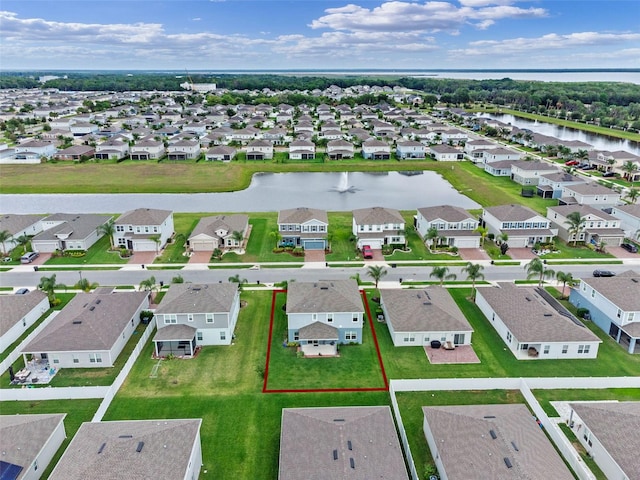 birds eye view of property featuring a residential view and a water view