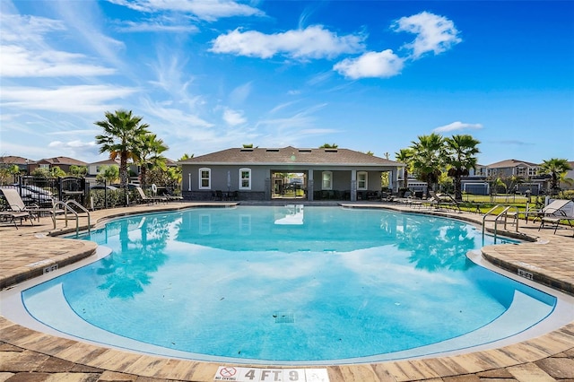 pool featuring a patio area and fence