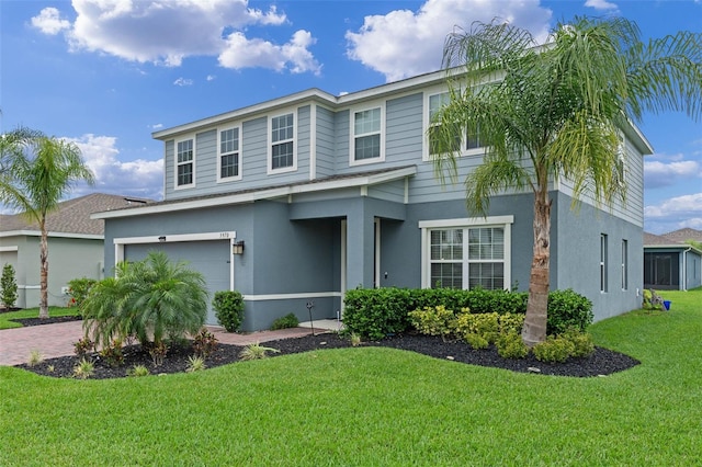 view of front of property with an attached garage, driveway, stucco siding, and a front lawn