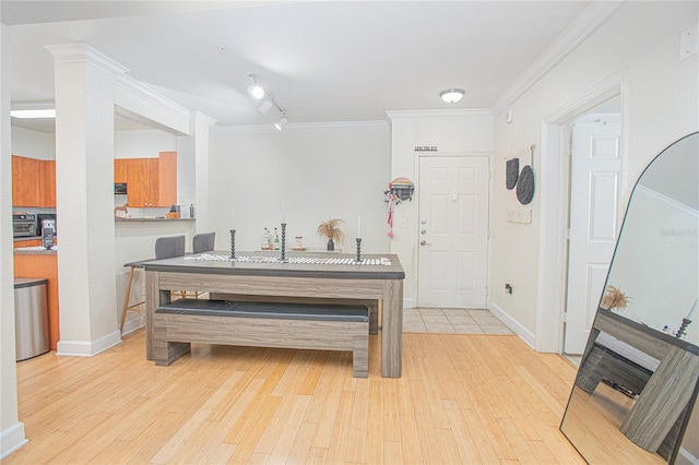 204 E S St Unit 2061, Orlando, FL 32801 - dining space with crown molding, rail lighting, light wood-style flooring, and baseboards